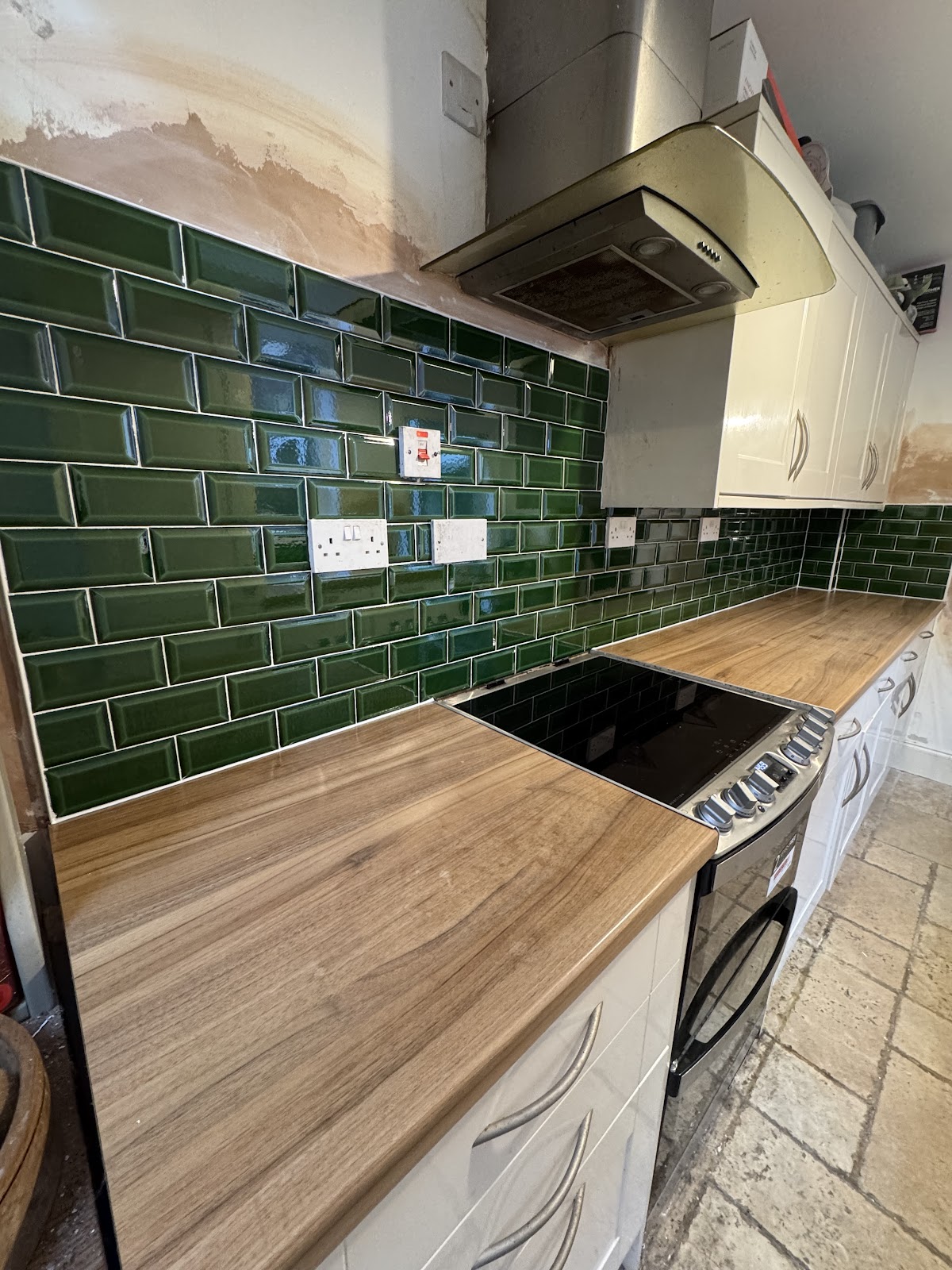 Dark green bevelled metro tile kitchen splashback