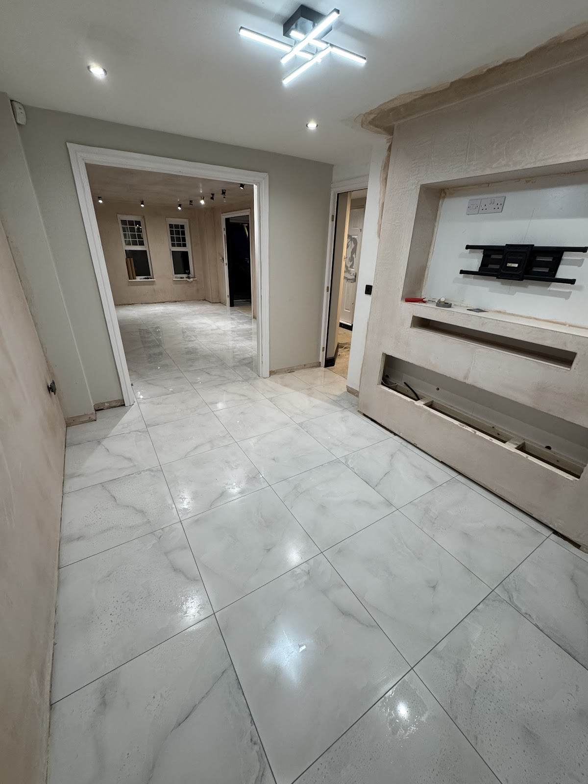 Polished marble-effect floor tiles running through a hallway